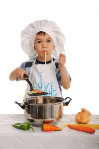 Child is cooking spaghetti